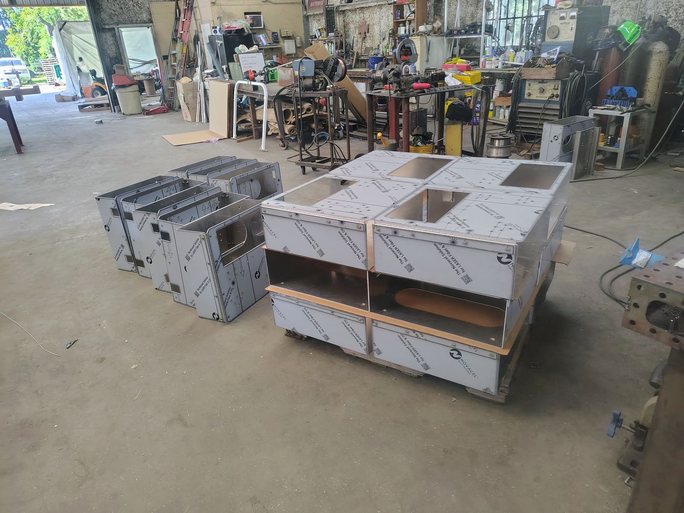 A production run of fabricated aluminum enclosures on pallets in the shop