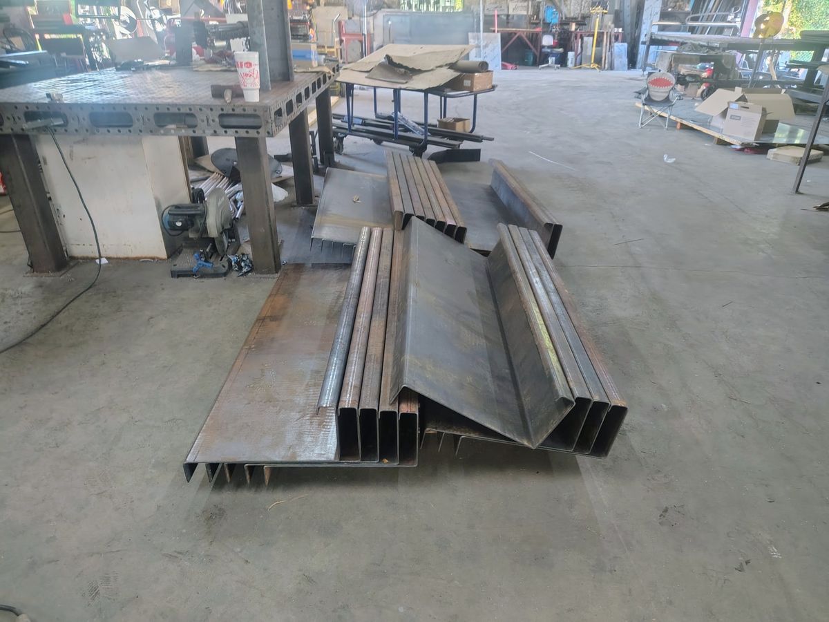 Formed steel trailer frame support sections in the shop