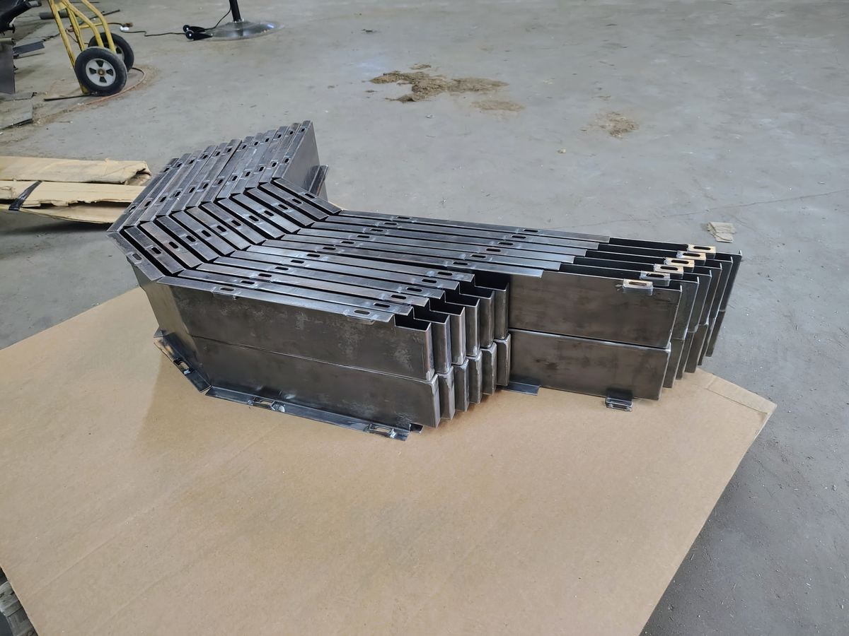 Stack of formed steel channel weldment parts on a pallet